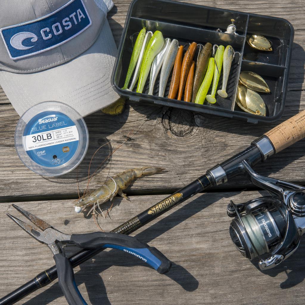 Inshore fishing tackle laid out on a weathered dock